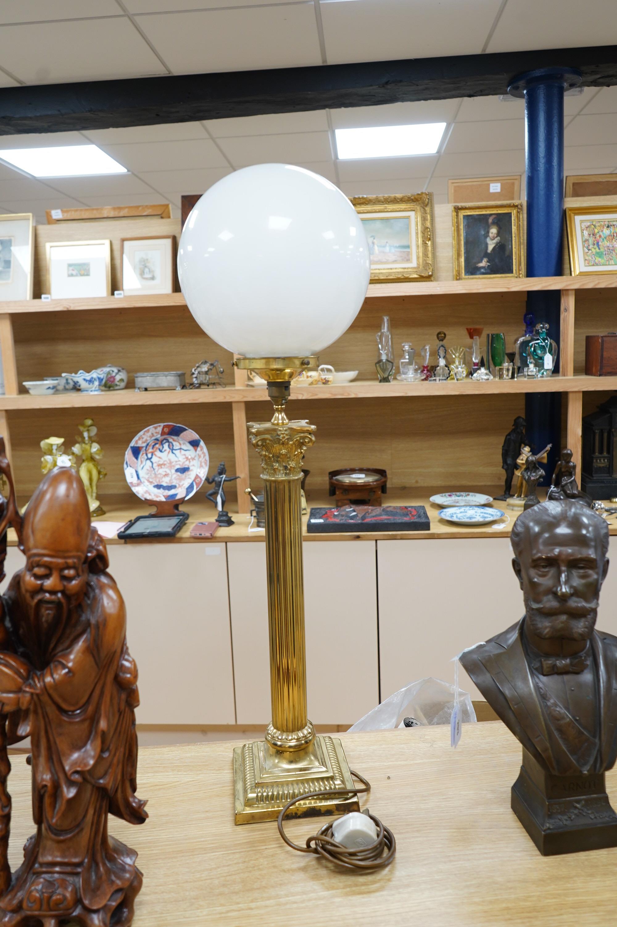 A tall brass Corinthian column table lamp with spherical glass shade, 84cm high including glass shade. Condition - good, brass tarnished at base